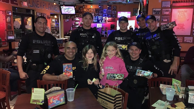 Girl Scouts donate cookies to police officers