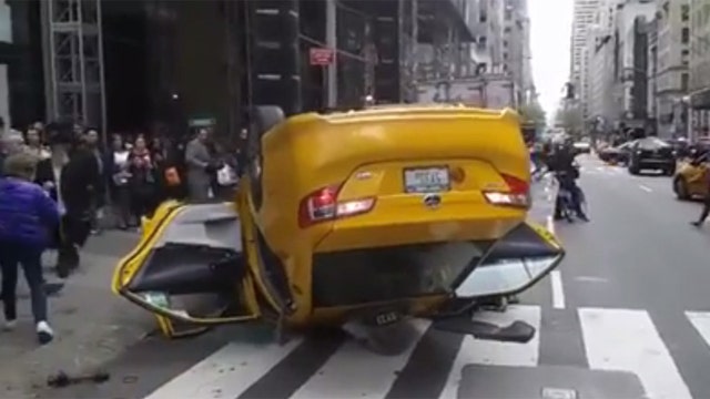 Taxi flips over in Midtown Manhattan