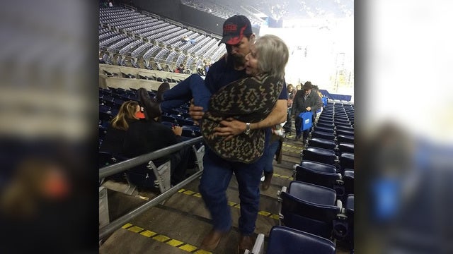 Good Samaritan carries elderly woman struggling to use stairs at Houston rodeo