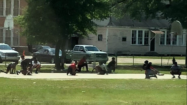 Young basketball players show respect to passing funeral