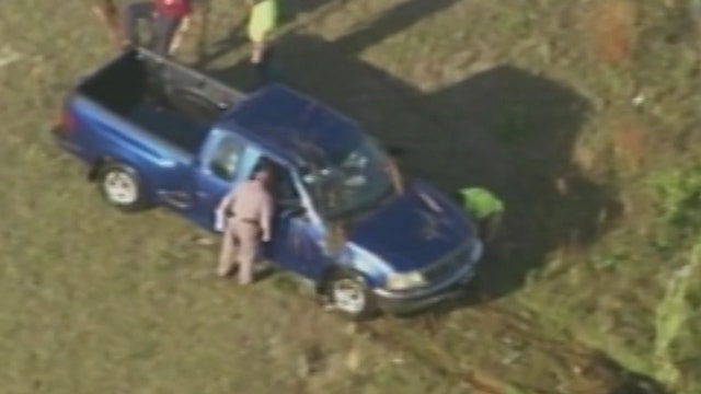 Man rescued from truck submerged in pond