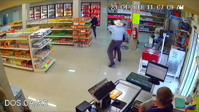 Cowboy tackles robber waving gun