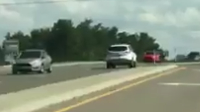 Video shows SUV traveling on wrong side of busy road