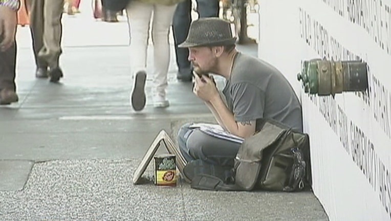 bfa282f5-man-sitting-on-sidewalk_1526583003608-402970.jpg