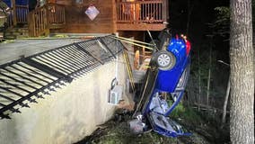 Driver and dog safely rescued from dangling car in Tennessee