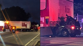 Woman found dead in SUV trapped under tractor-trailer, police say
