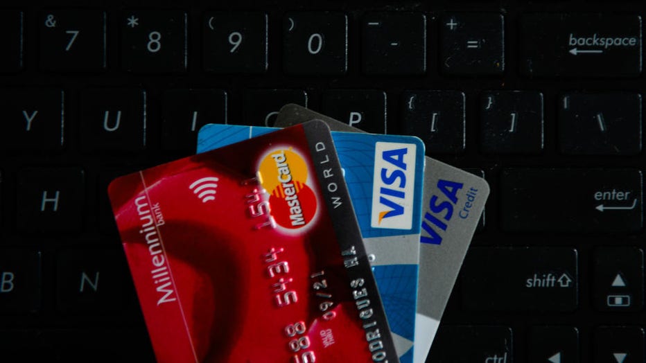 VISA and Mastercards credit cards are seen on  the top of a