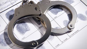 Police officer arrested, accused of brandishing gun at bar