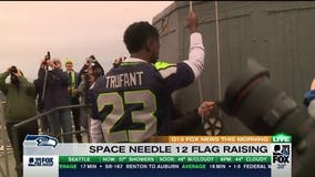 GO HAWKS!  Marcus Trufant raises 12 flag atop Space Needle (VIDEO)