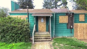 Half a million dollars could buy you this boarded up Seattle home