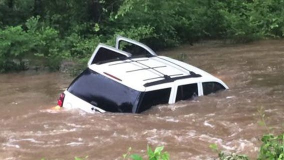 Heroes use rope to pull man, 'very friendly' dog from flood waters