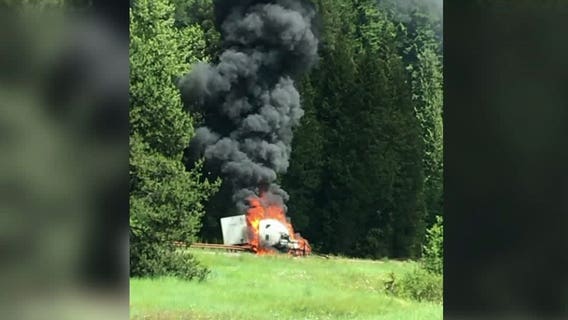 Truck driver rushed to hospital after semi crashes, catches fire on I-90