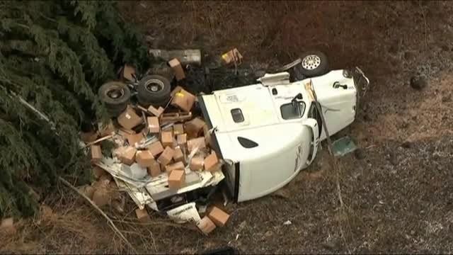 Semi crashes over 50-foot embankment in Oregon, driver and passenger OK