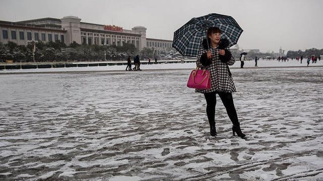 Beijing advises umbrellas to shield against its 'very dirty' snow