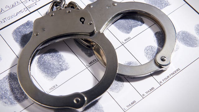 Police officer arrested, accused of brandishing gun at bar