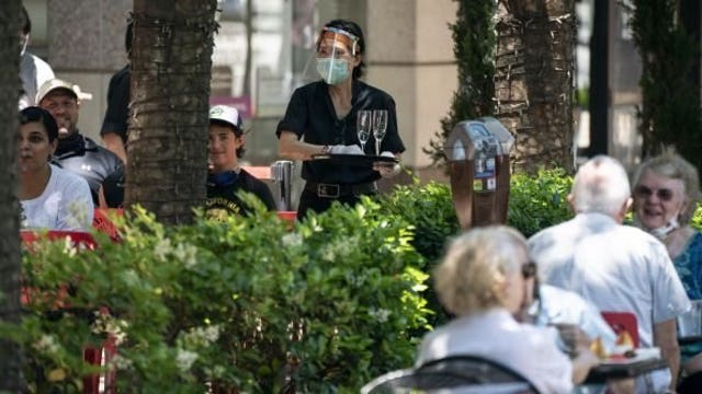 Some states hit pause, others press on amid spike in coronavirus