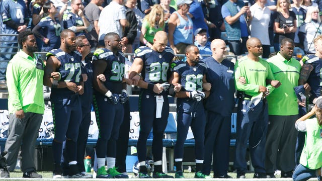 Seahawks follow through with plan to link arms during anthem
