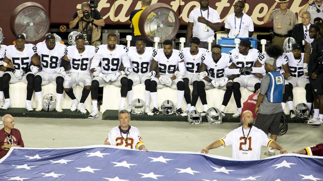 Do NFL rules say players must stand during the anthem?
