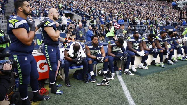 Nine Seahawks sit on bench during national anthem