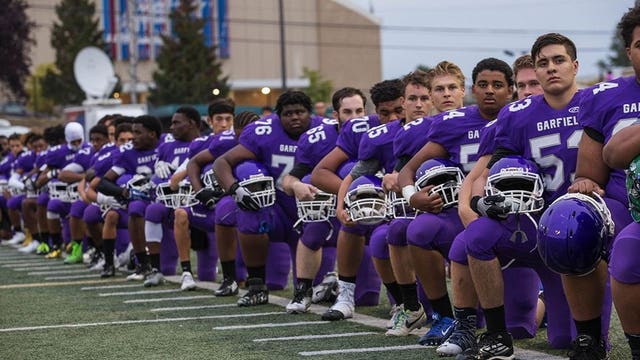 Entire Seattle high school football team kneels during national anthem before game
