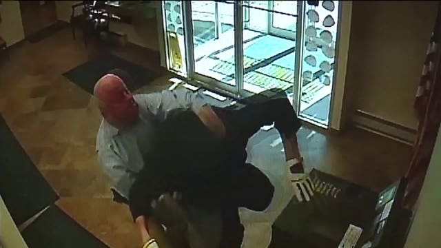 Surveillance video shows bank customer tackle armed robber