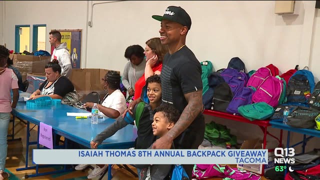Tacoma native Isaiah Thomas hands out backpacks to students in need