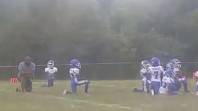 8-year-old football players kneel during national anthem before game