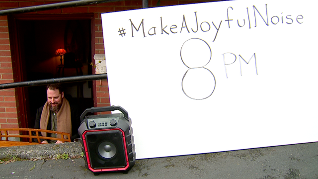 People shout, cheer, and make noise in support of health care workers