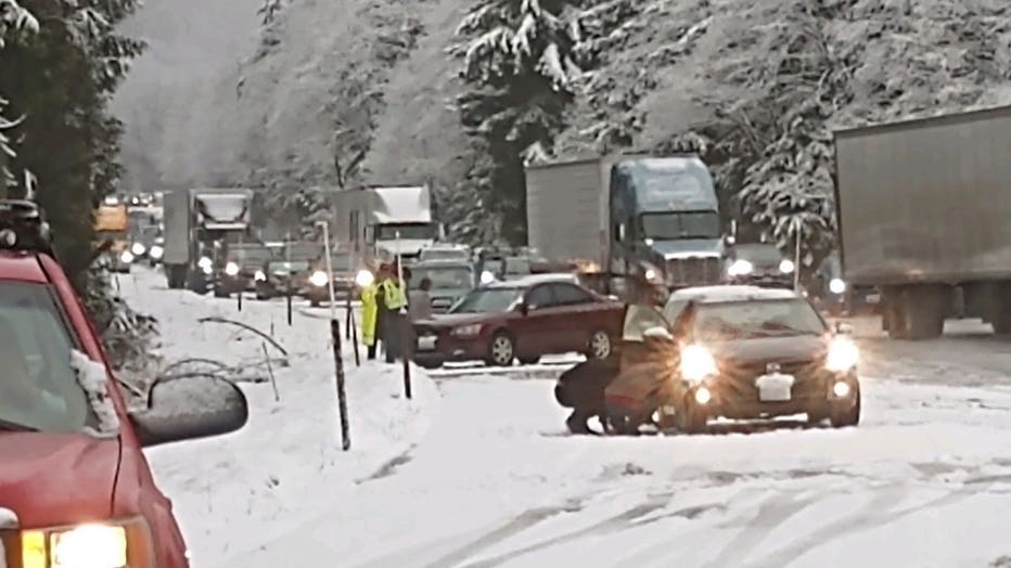 cars stuck in snow at on snoqualmie pass