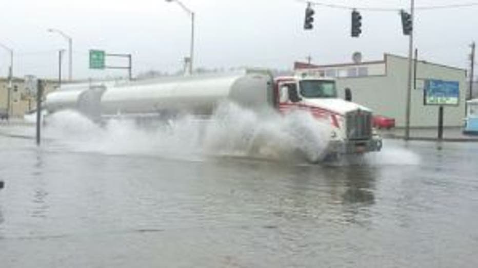 semi driving flooded street