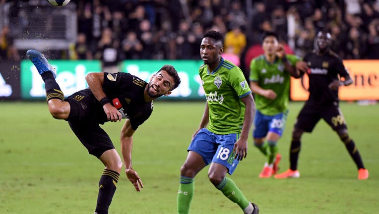 FILE - Diego Rossi #9 of Los Angeles FC plays a ball in front of Kelvin Leerdam #18 of Seattle Sounders during the second half in a 3-1 Sounders win during the Western Conference finals at Banc of California Stadium on Oct. 29, 2019 in Los Angeles, California. 