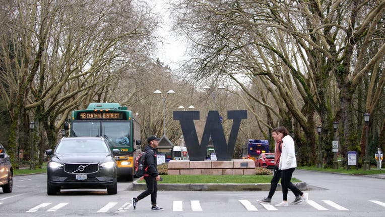 FILE - Students at the University of Washington are on campus for the last day of in-person classes.