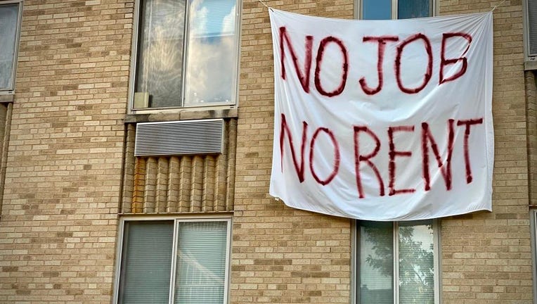 FILE - A banner against renters eviction is displayed on a controlled rent building in Washington, D.C. on Aug. 9, 2020.