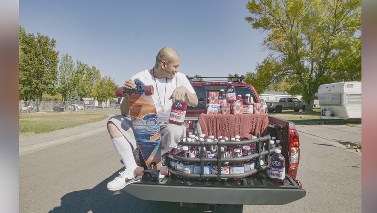 Nathan Apodaca with his new truck and cranberry juice gifted by Ocean Spray.