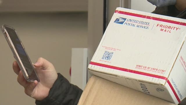 Customers wait in long lines to ship last minute gifts during unprecedented holiday season