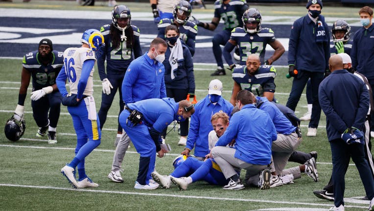 Los Angeles Rams head coach Sean McVay talks to quarterback John Wolford (13)  before an NFL