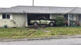 Car crashes into Parkland home, trapping man inside his living room