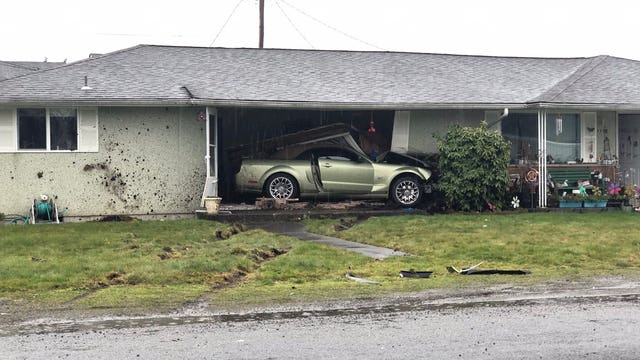 Car crashes into Parkland home, trapping man inside his living room