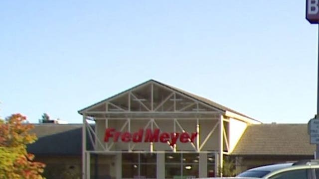 Police guard dumpsters full of discarded food at Fred Meyer