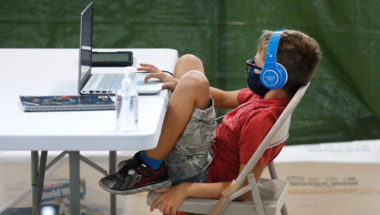 FILE - A third grade student sits during his online class from his social distanced desk on Sept. 3, 2020 in Los Angeles, California. (Photo: Al Seib / Los Angeles Times via Getty Images)