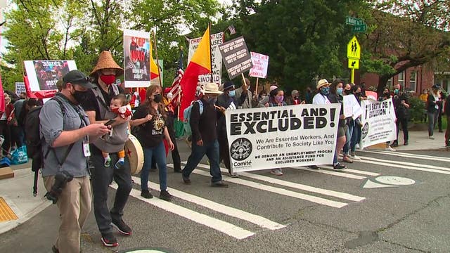 Demonstrators march in solidarity for immigrant workers in Seattle on May Day