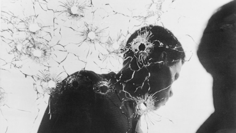 Man Behind Bullet-Riddled Glass