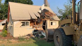 Police: Man drove through several counties in stolen school bus before crashing front-end loader into home