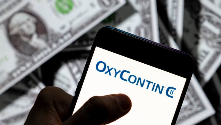 FILE - In this photo illustration, the OxyContin painkiller drug logo produced by Purdue Pharma is displayed on a smartphone. (Photo Illustration by Budrul Chukrut/SOPA Images/LightRocket via Getty Images)