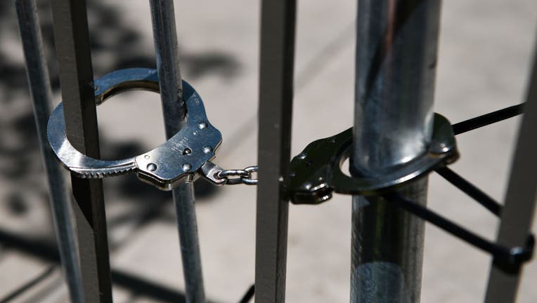 FILE - Handcuffs are pictured holding barricades together at a rally on June 27, 2020, in Aurora, Colorado. (Photo by Michael Ciaglo/Getty Images)