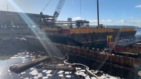 Crews cleaning up oil spill at Colman Dock