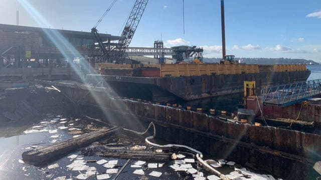 Crews cleaning up oil spill at Colman Dock