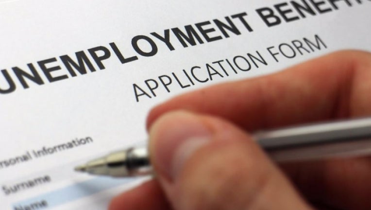 A person fills out an unemployment benefits application.