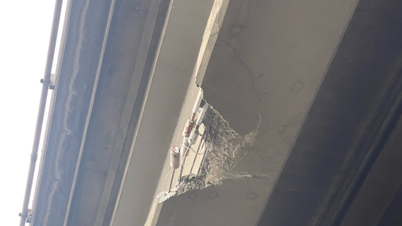 Excavator on semi hits, damages overpass above I-5 in Fife