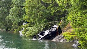 Child dies after driver goes over embankment, plunging into Lake Cushman